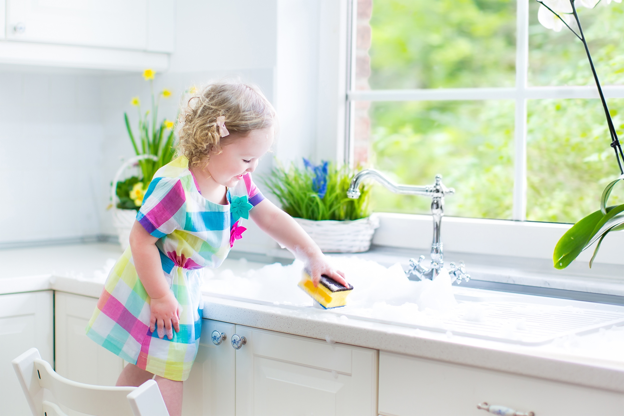 Child playing in sink
