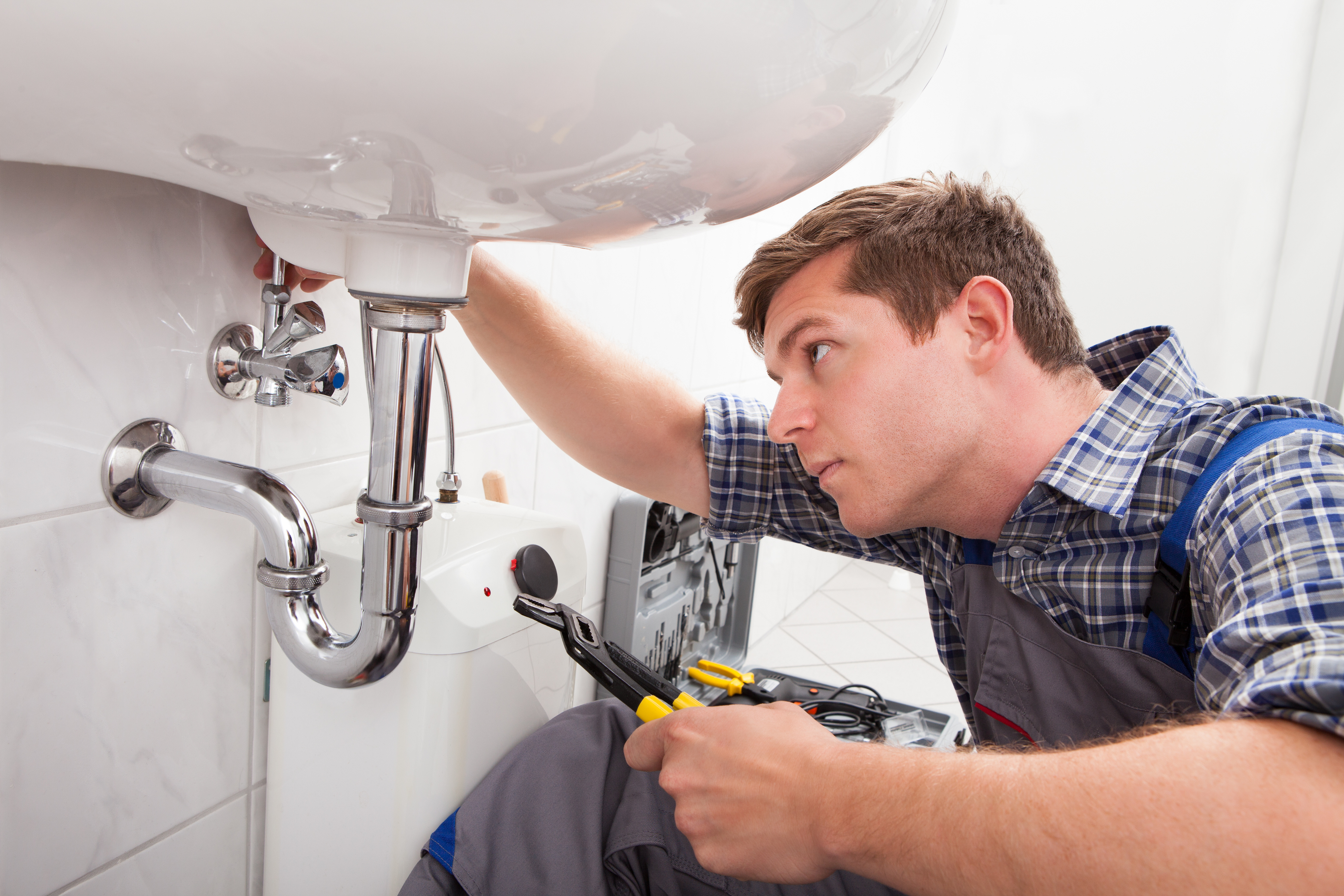 Plumber working on sink