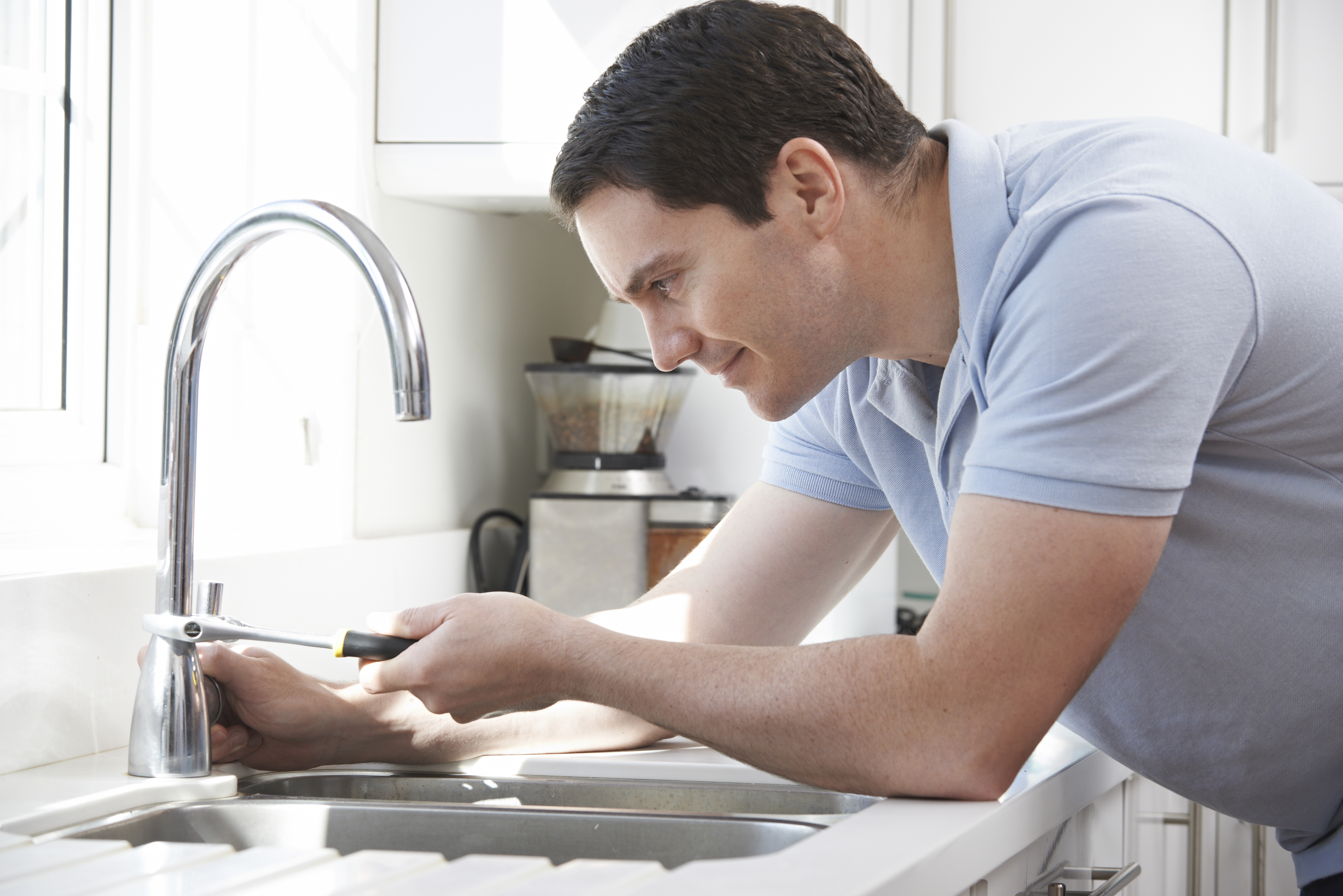 Man working on sink